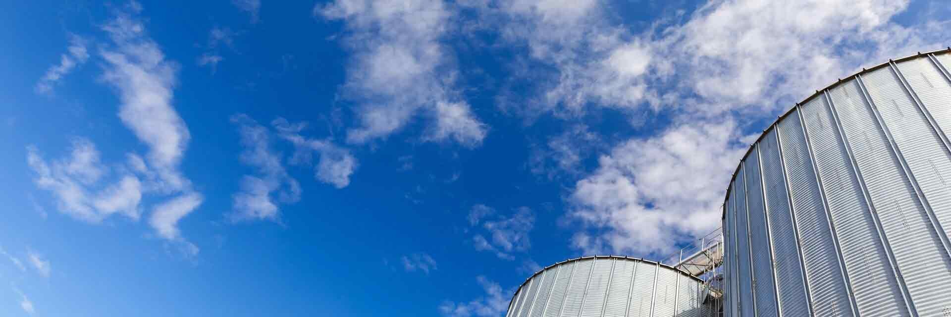 LEAG's silo storage facility for REKORD wood pellets against a blue sky